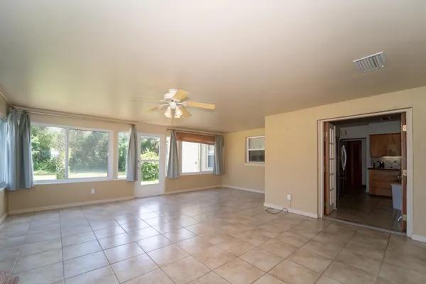 a view of an empty room with a fireplace and a large window