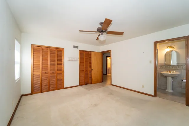 a view of a livingroom with a ceiling fan and entryway