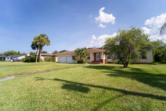 an aerial view of residential house with outdoor space and swimming pool
