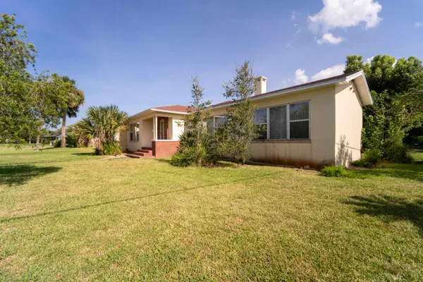 a view of yard with swimming pool and green space
