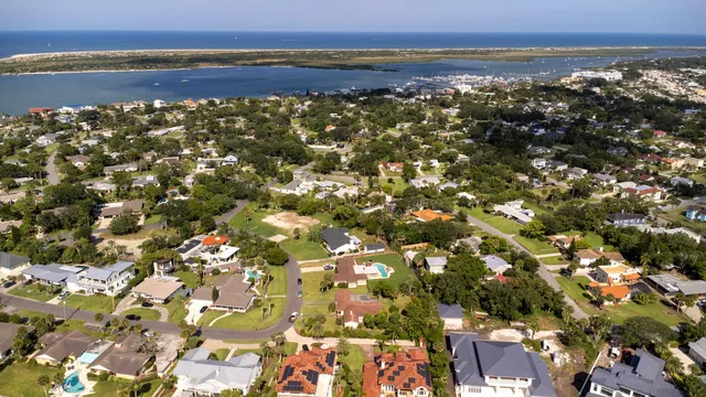 an aerial view of residential houses with outdoor space and street view