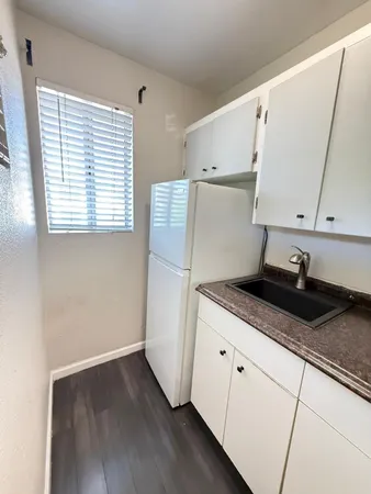a kitchen with granite countertop a sink and a stove