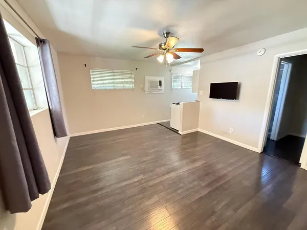 wooden floor in an empty room with a window