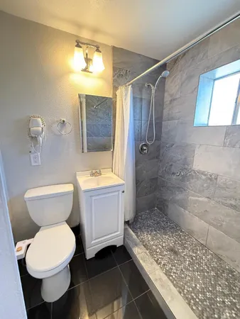 a bathroom with a sink toilet and shower