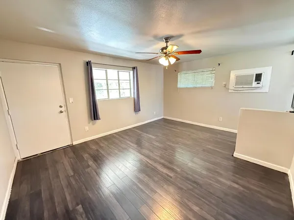 wooden floor in an empty room with a window