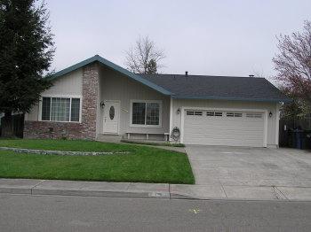 1542 Golf Course Drive Rohnert Park, CA 94928 - Photo 1 of 9 a front view of a house with a garden and yard