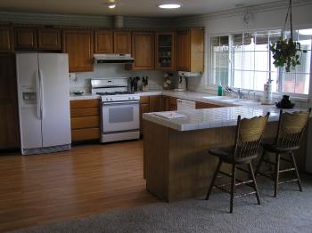 1542 Golf Course Drive Rohnert Park, CA 94928 - Photo 5 of 9 a kitchen with a table chairs a sink a window and stainless steel appliances