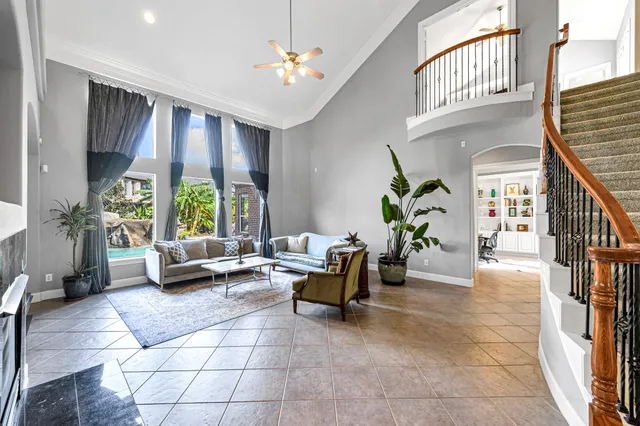 a living room with furniture and a potted plant