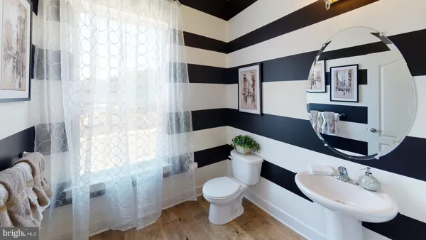 a bedroom with a bed and a mirror on dresser