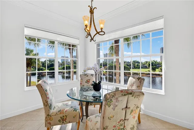 a dining room with furniture large windows and wooden floor