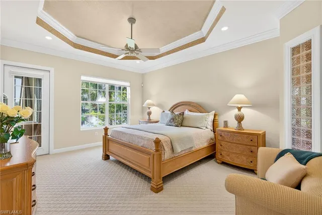 a spacious bedroom with a bed and a chandelier