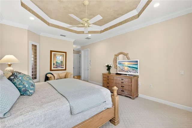 a bedroom with a bed and ceiling fan