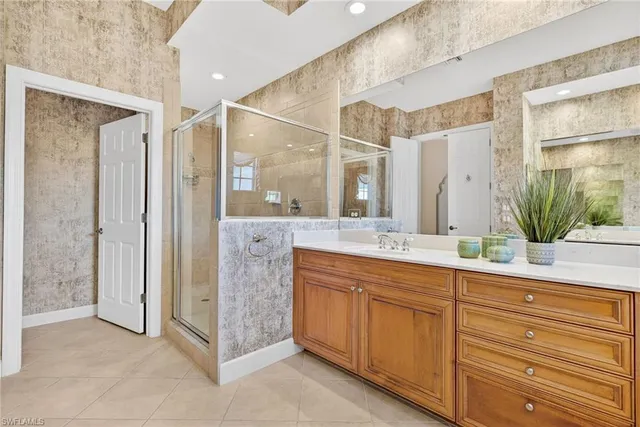 a spacious bathroom with a double vanity sink and a mirror