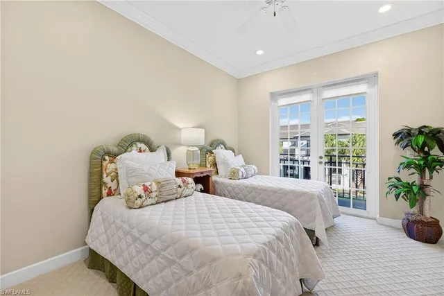 a bedroom with two beds and potted plant