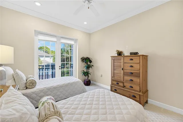 a bedroom with furniture and a large window