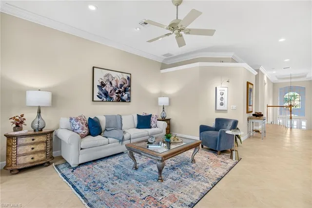 a living room with furniture a rug and a chandelier