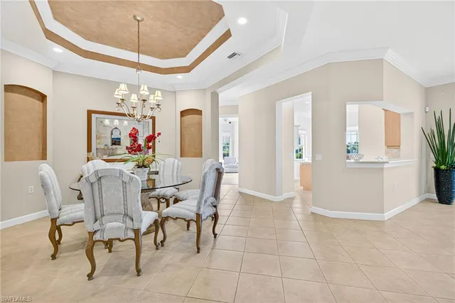 a view of a dining room with furniture and chandelier