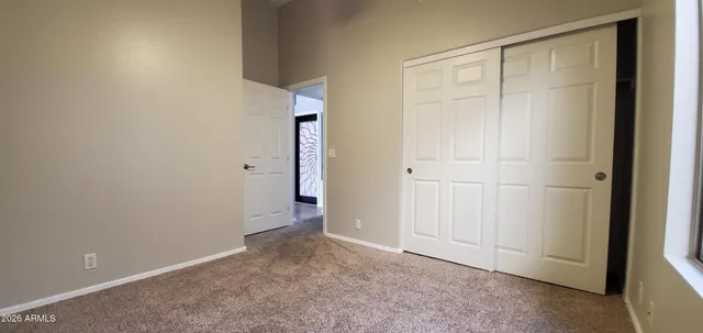 an empty room with closet area