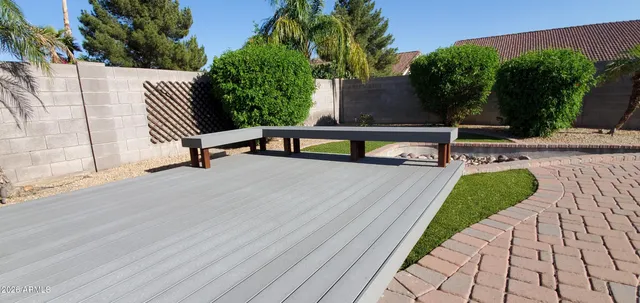 a view of backyard with a table and chairs