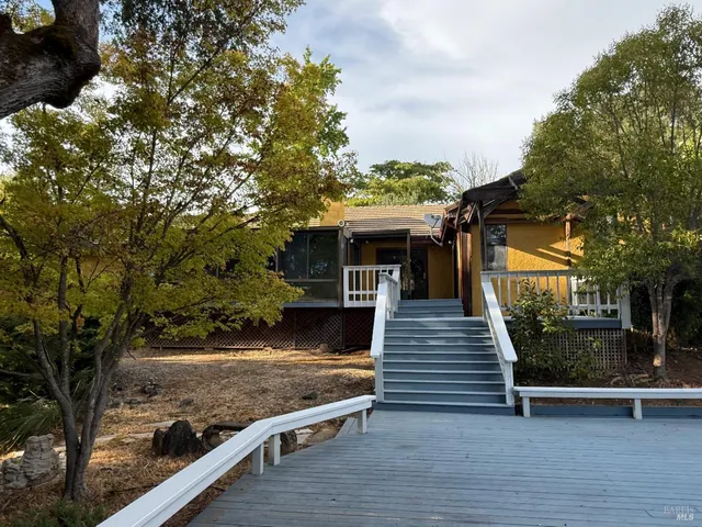 a view of a yard with wooden fence
