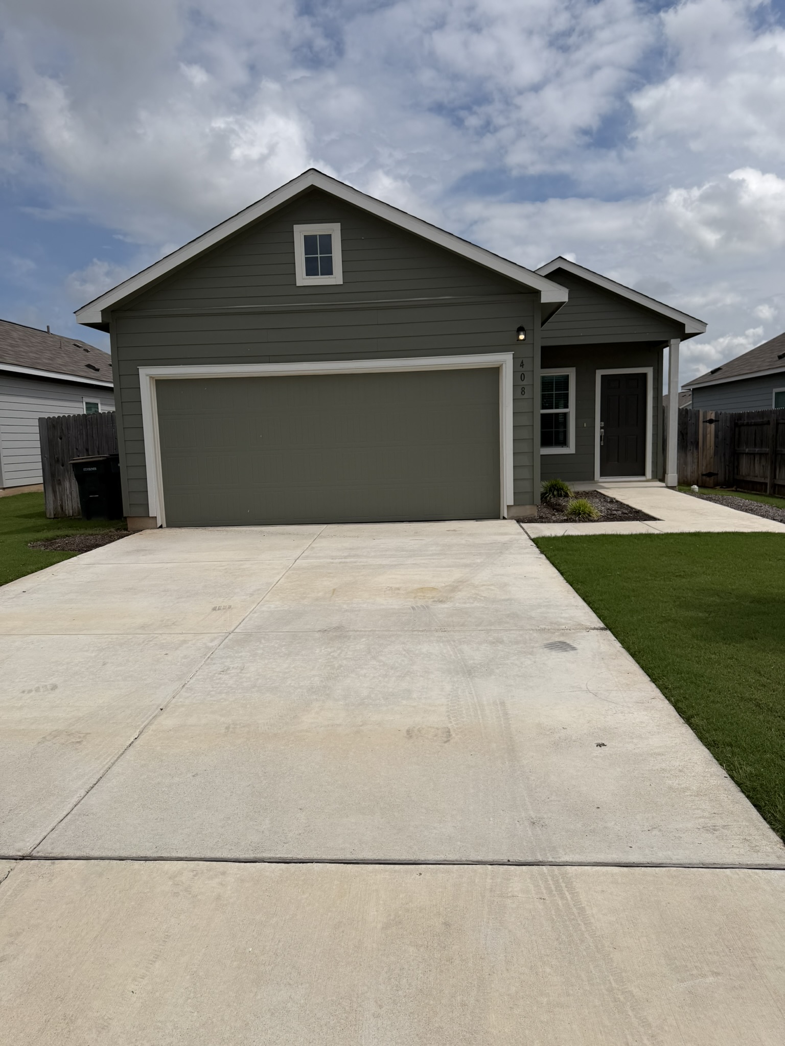 408 Buckners Street Georgetown, TX 78626 - Photo 1 of 15 a front view of a house with a yard and garage