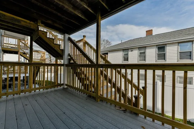 a front view of a house with wooden deck