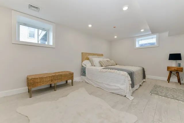 a spacious bedroom with a bed a table and chair