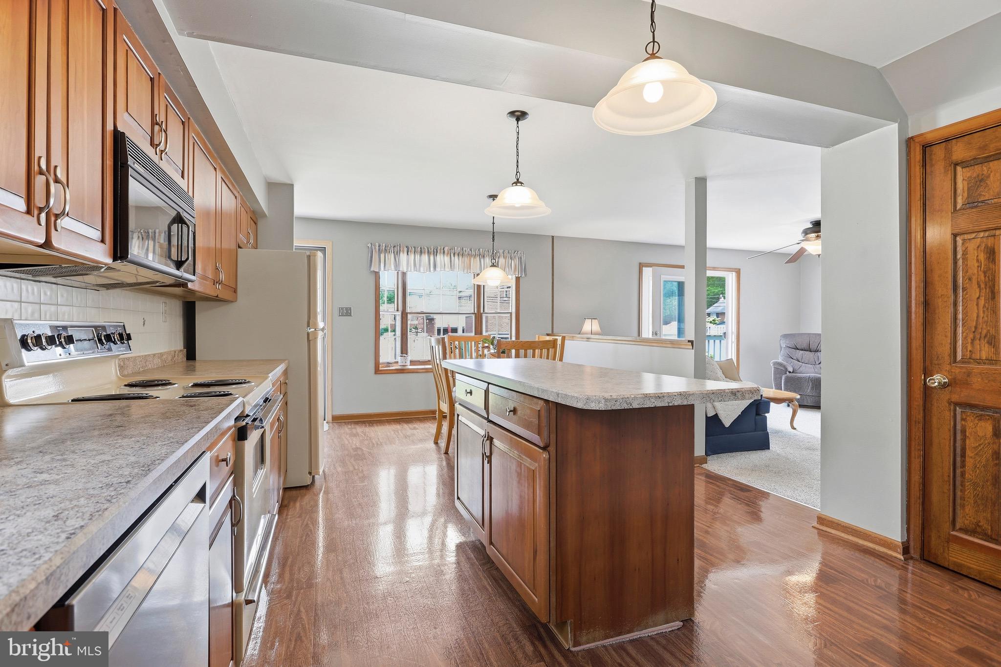 527 Saxer Avenue Springfield, PA 19064 - Photo 14 of 33 a kitchen with a stove and a wooden floor