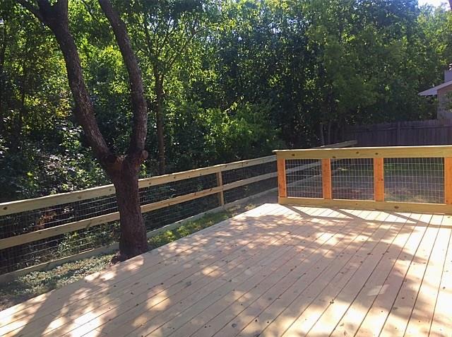 3305 Spaniel Drive Austin, TX 78759 - Photo 9 of 20 A spacious wooden deck provides an elevated outdoor retreat amidst verdant surroundings.