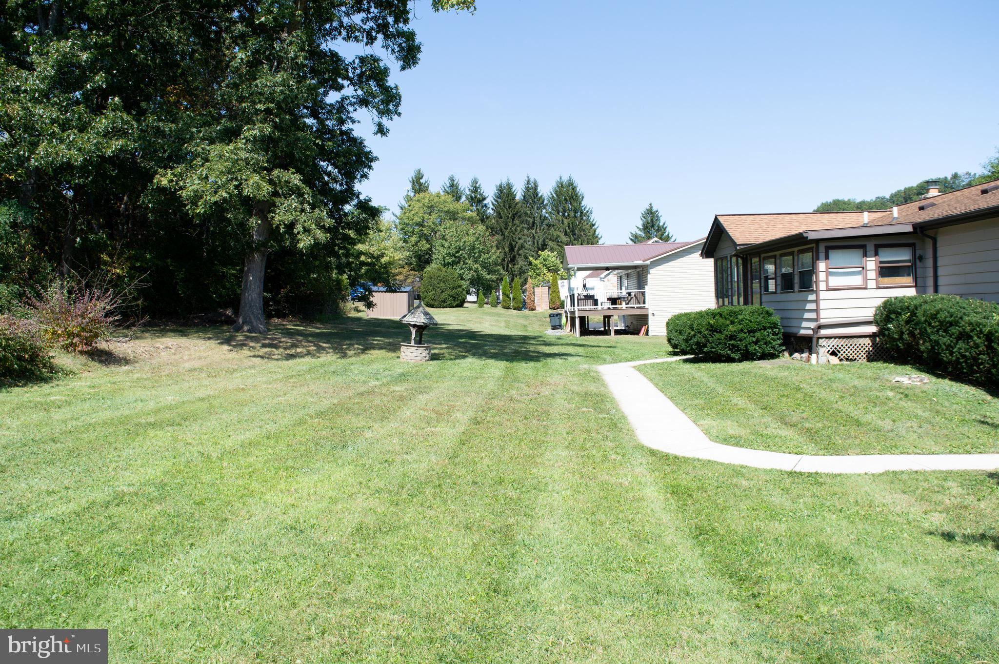 12713 Winchester Road Cumberland, MD 21502 - Photo 13 of 55 a view of a house with a backyard and a patio