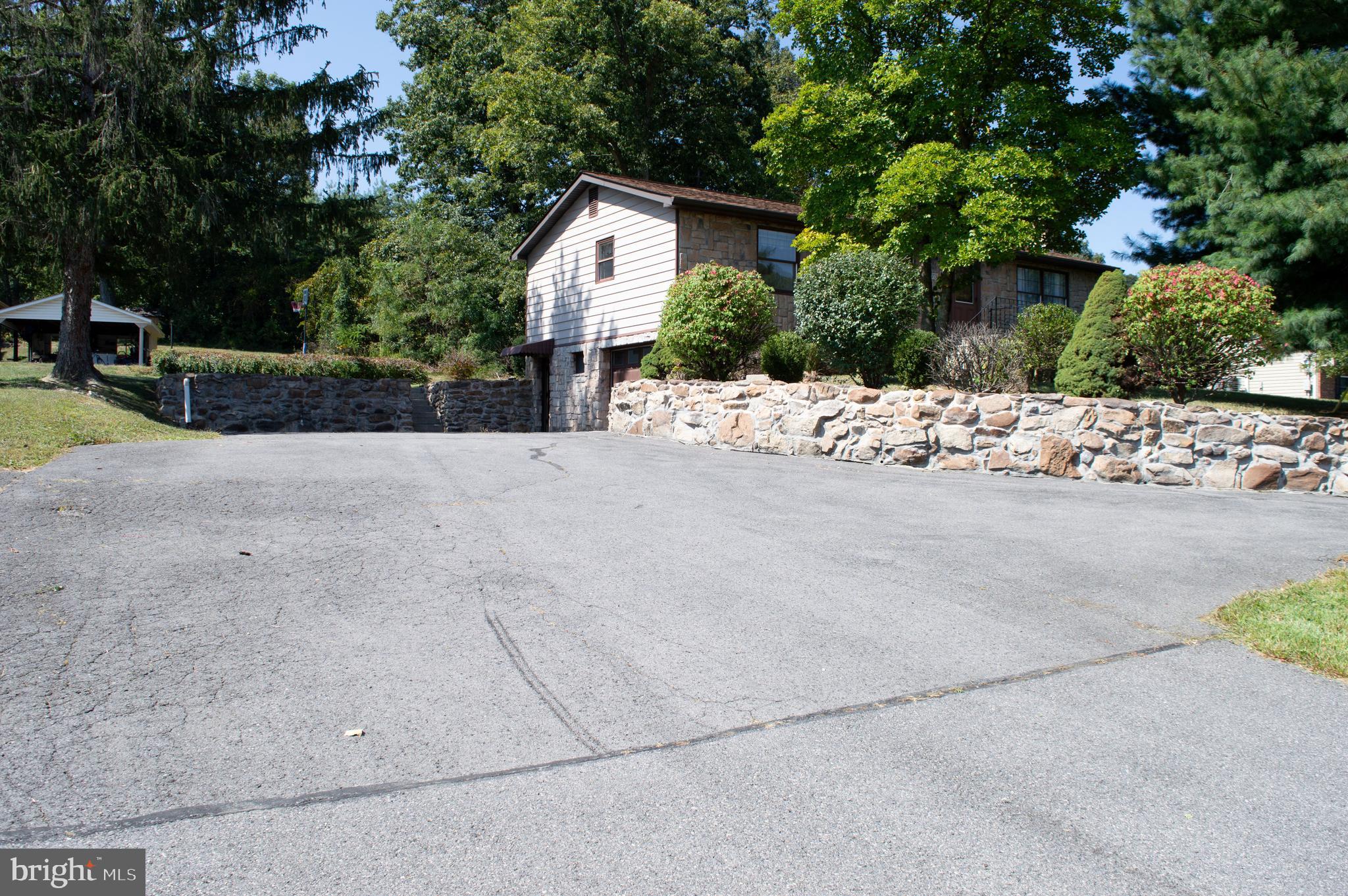 12713 Winchester Road Cumberland, MD 21502 - Photo 14 of 55 a view of a house with a yard and large tree
