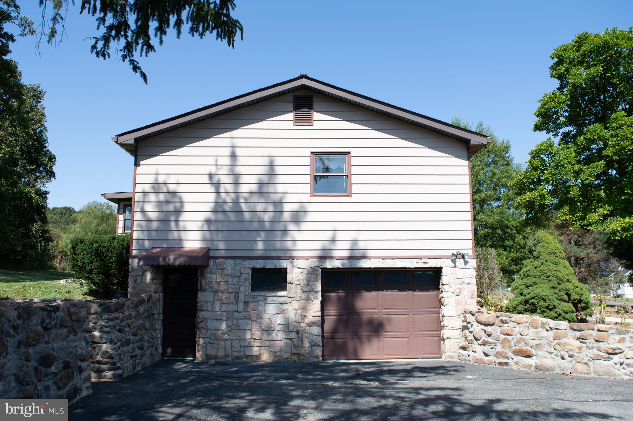 12713 Winchester Road Cumberland, MD 21502 - Photo 16 of 55 a front view of a house with a yard