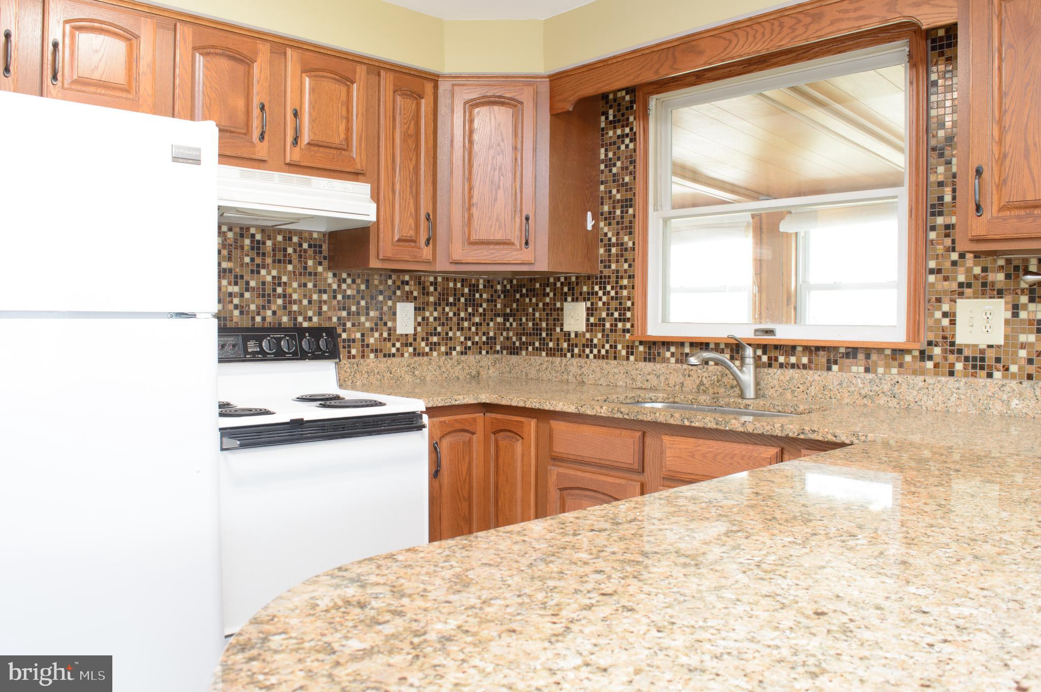 12713 Winchester Road Cumberland, MD 21502 - Photo 20 of 55 a kitchen with granite countertop a sink and a stove