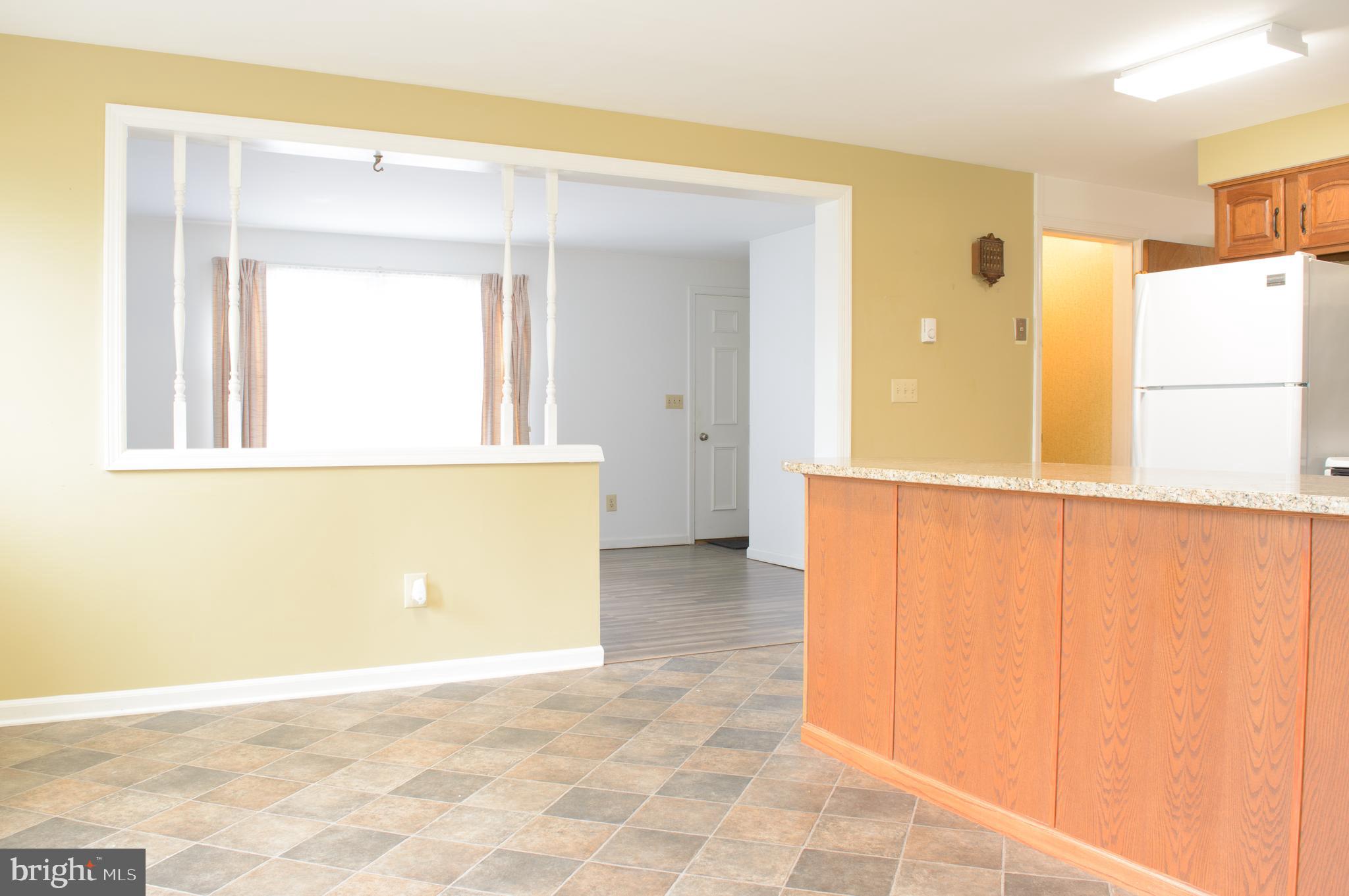 12713 Winchester Road Cumberland, MD 21502 - Photo 27 of 55 a view of a kitchen with a refrigerator and a window