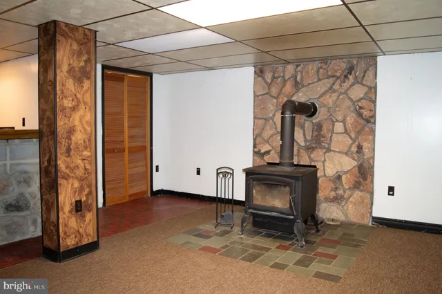 a room with pool table and windows