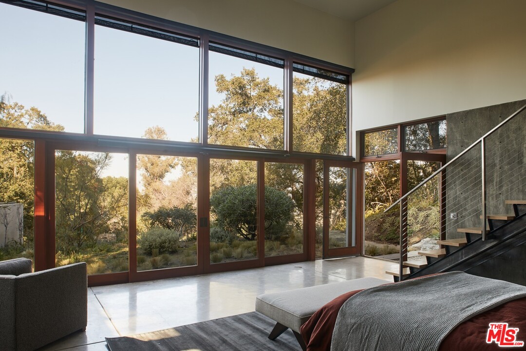 3201 Coldwater Canyon Lane Beverly Hills, CA 90210 - Photo 13 of 23 a bedroom with furniture and large windows