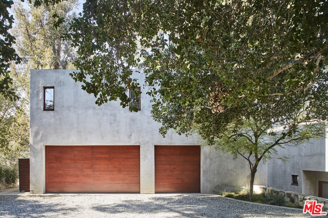 3201 Coldwater Canyon Lane Beverly Hills, CA 90210 - Photo 2 of 23 a front view of a house with trees