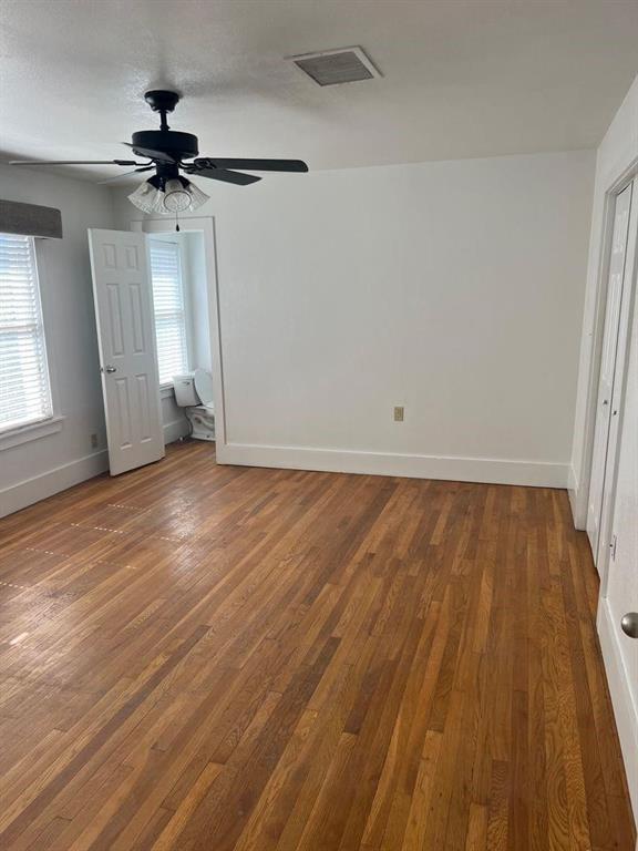 1209 Bawcom Street Sweetwater, TX 79556 - Photo 7 of 10 wooden floor in an empty room with a window