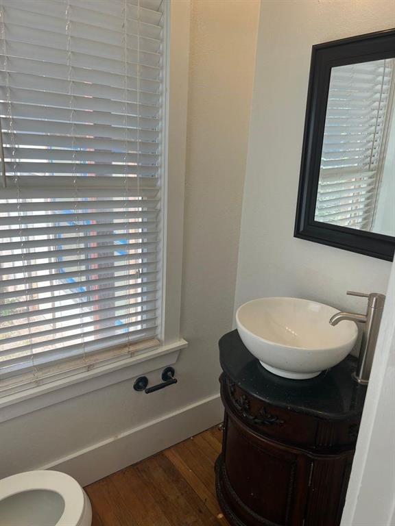 1209 Bawcom Street Sweetwater, TX 79556 - Photo 9 of 10 a bathroom with a toilet a sink and a window
