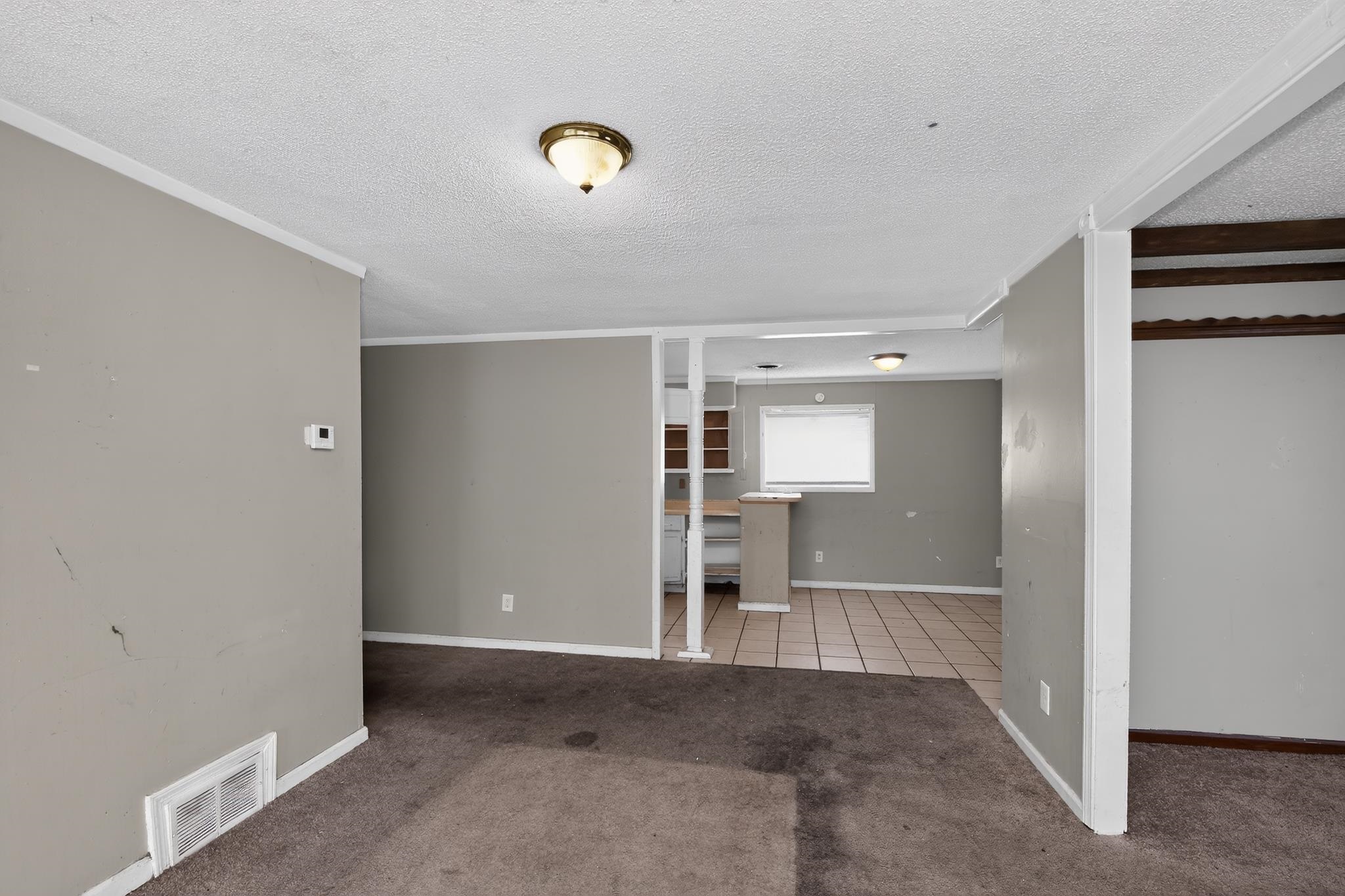 3791 Windermere Road Memphis, TN 38128 - Photo 8 of 18 Open concept living space featuring neutral gray wall paint and textured carpet flooring