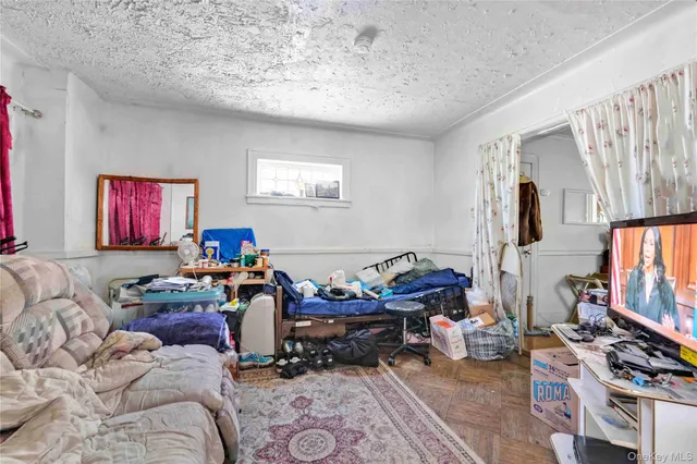 a living room with furniture a flat screen tv and a window