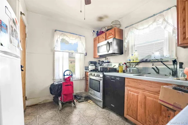 a kitchen with a sink stove and refrigerator