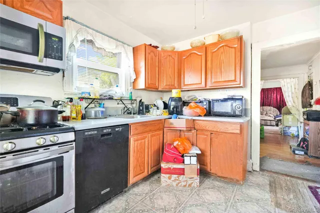 a kitchen with stainless steel appliances granite countertop a stove top oven a sink dishwasher and cabinets