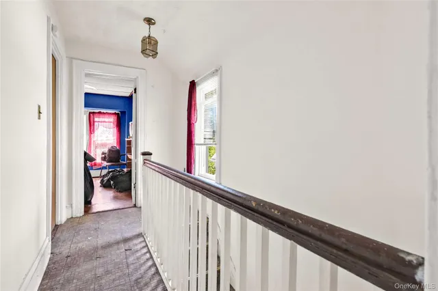 a view of a hallway and a livingroom with furniture