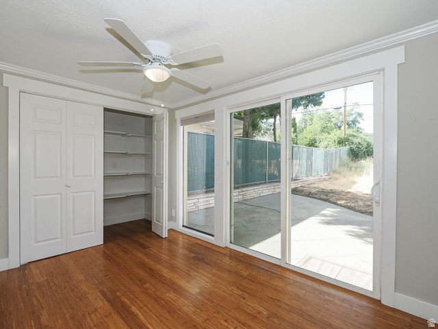 154 East 3000th Street South Bountiful, UT 84010 - Photo 11 of 37 Room featuring wood-finish flooring, a ceiling fan with integrated lighting, and a closet with bifold doors and built-in shelving
