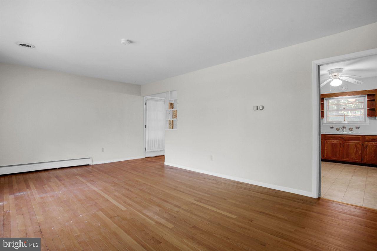 3409 River Road Reading, PA 19605 - Photo 4 of 41 a view of an empty room with wooden floor and a window