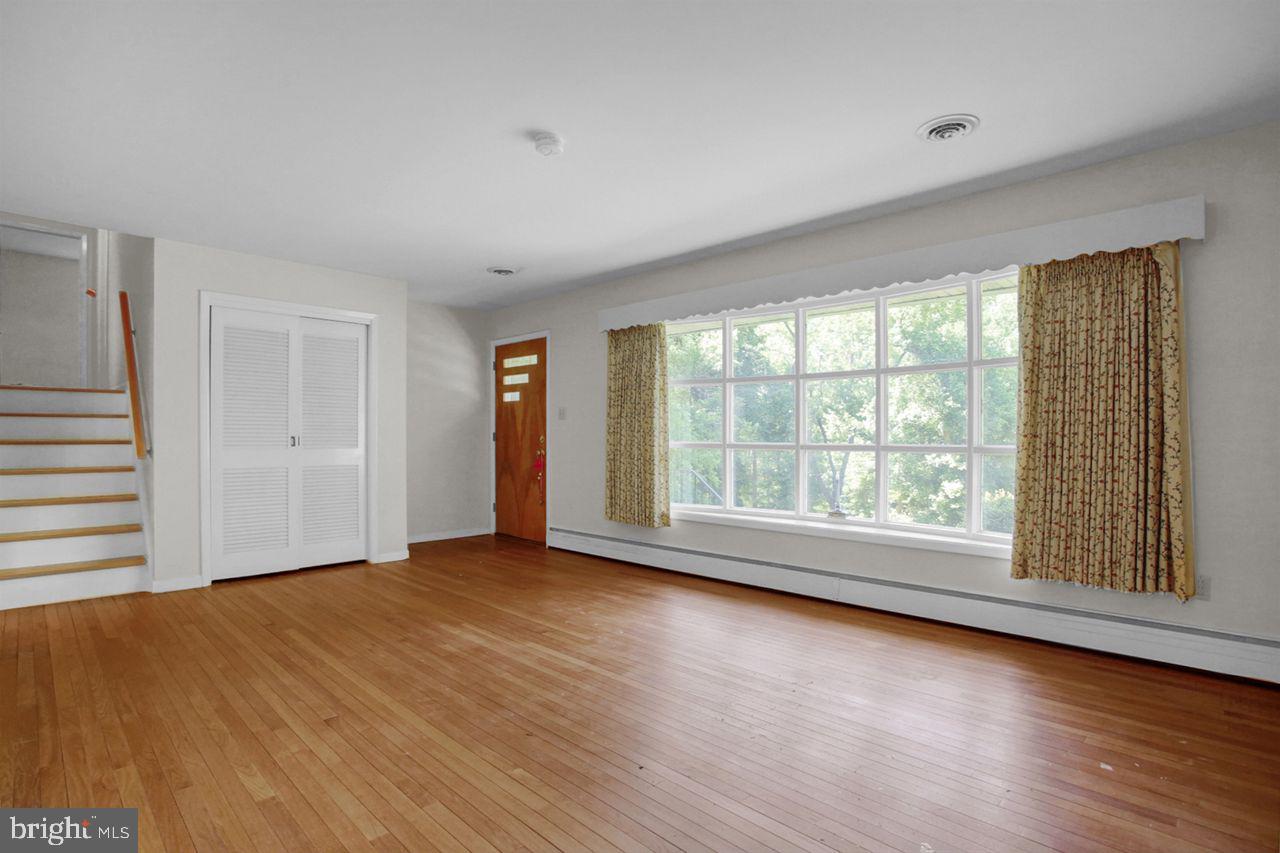 3409 River Road Reading, PA 19605 - Photo 5 of 41 a view of an empty room with wooden floor and a window