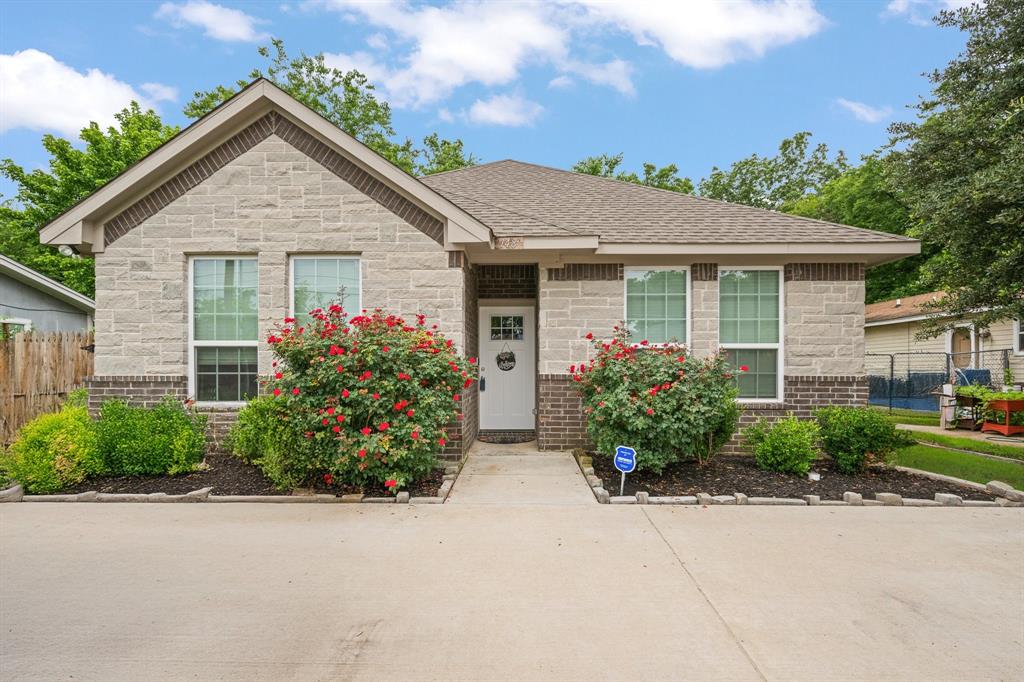 front view of house with potted plants