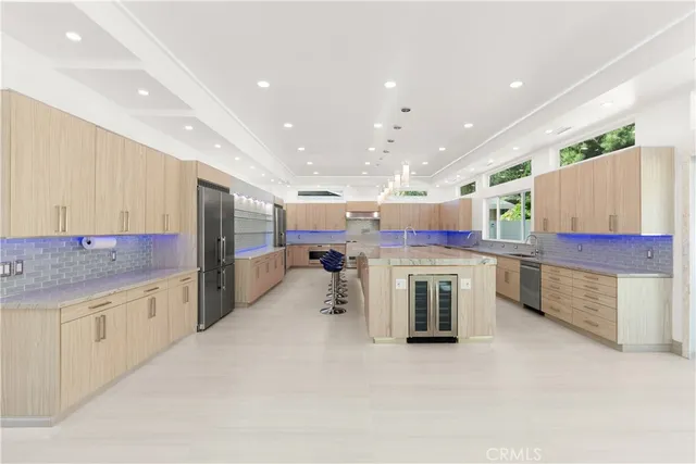 a kitchen with a sink and chairs