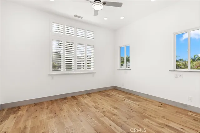 an aerial view of residential houses with outdoor space and trees all around
